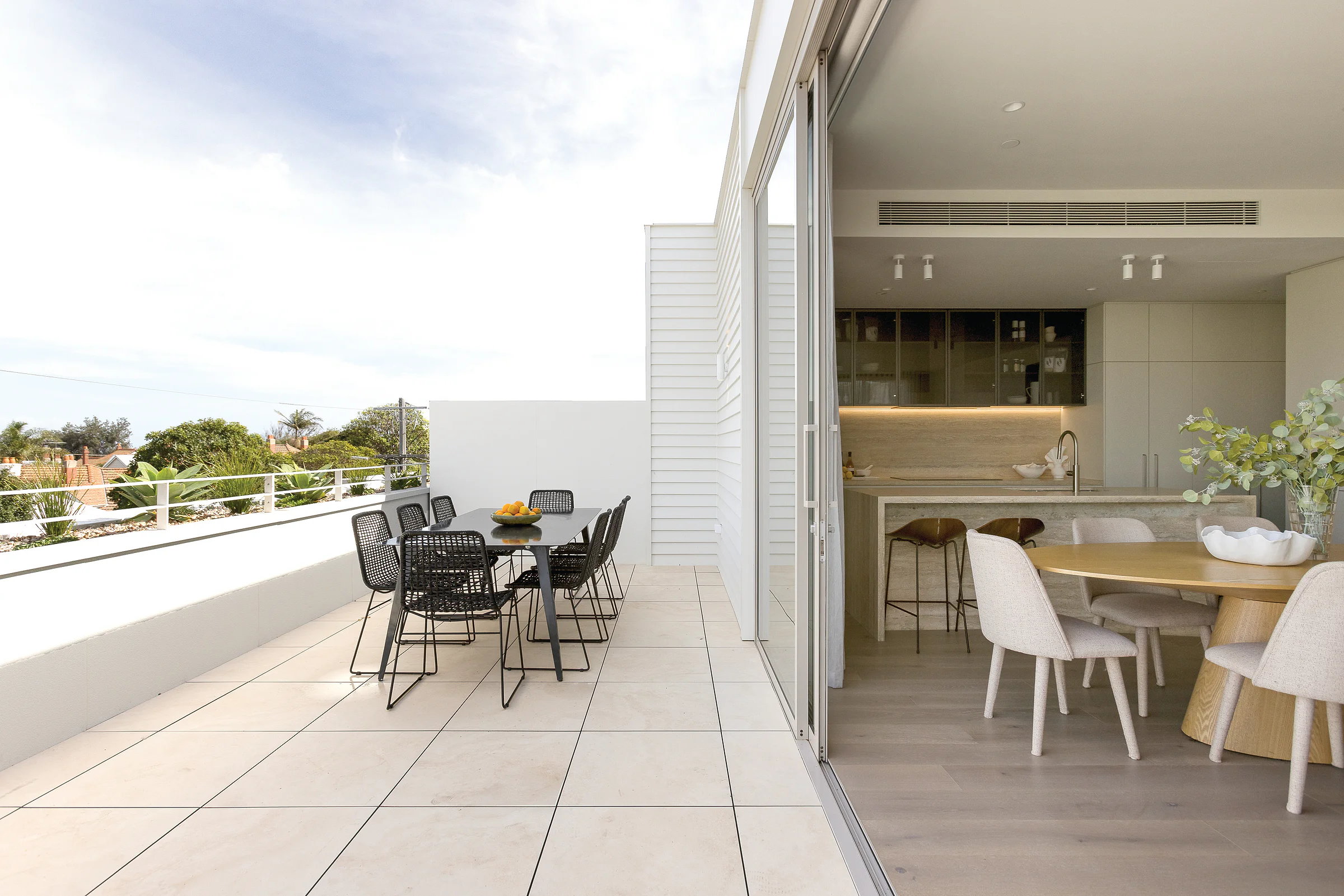 Sandringham Residences - Terrace and kitchen through floor-to-ceiling sliding glass doors