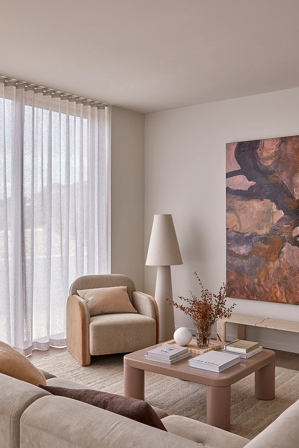 Sandringham Residences - Secondary lounge with curved armchair and abstract artwork